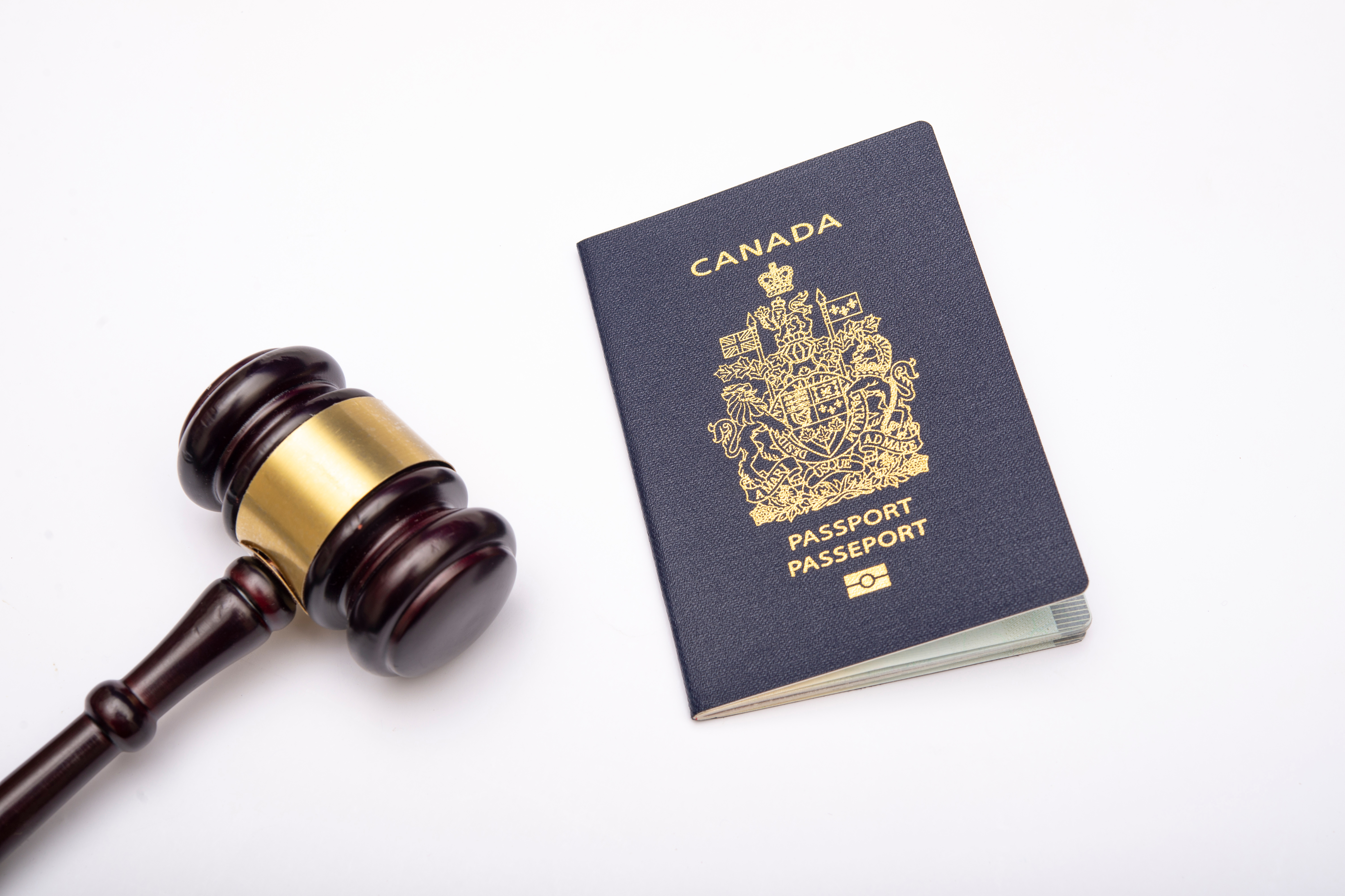Canadian passport and gavel symbolize Canadian citizenship