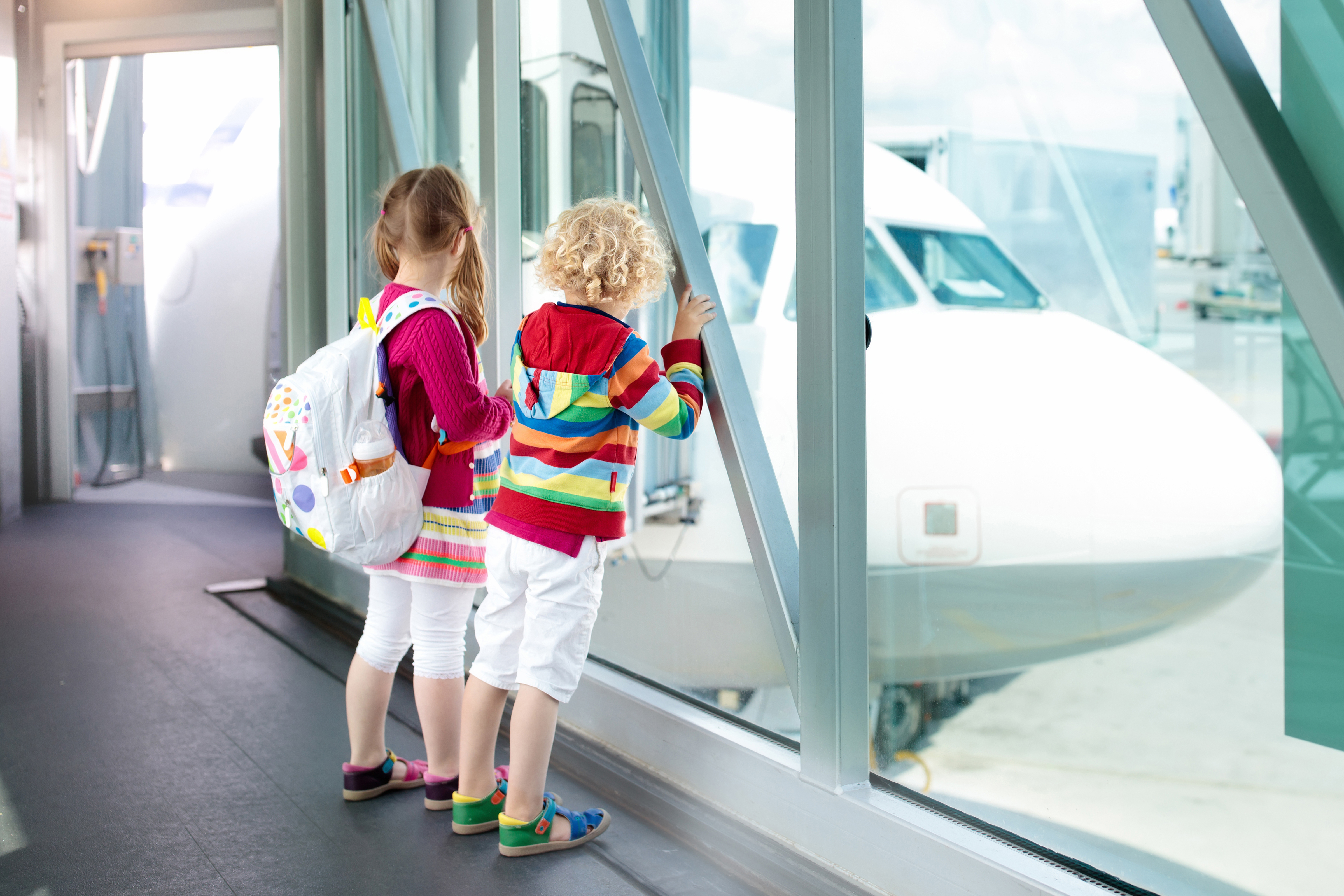 Children at the airport await parents who are undergoing Canadian visa checks