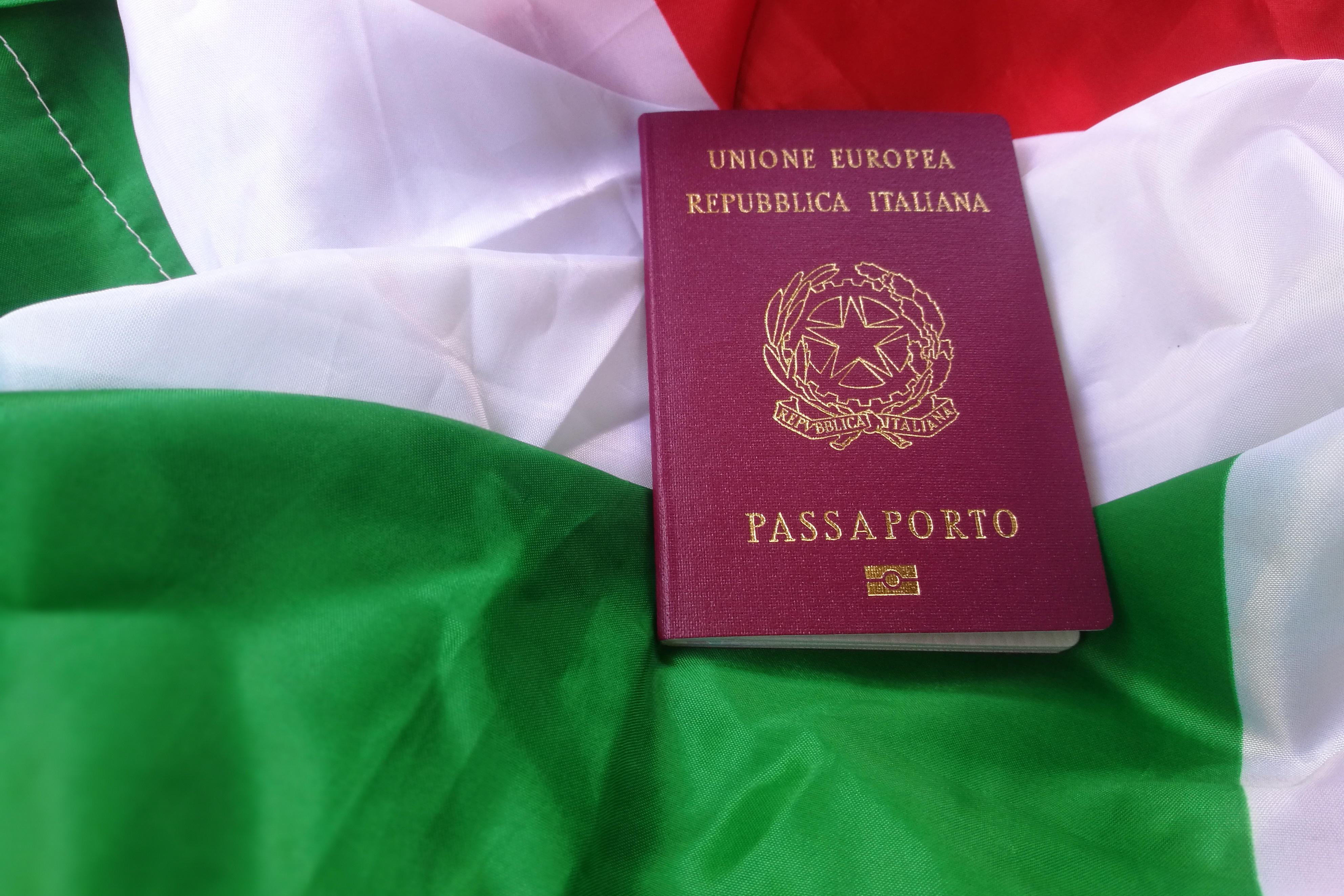 Italian passport on the flag, which can be obtained after purchasing real estate and obtaining a residence permit in Italy