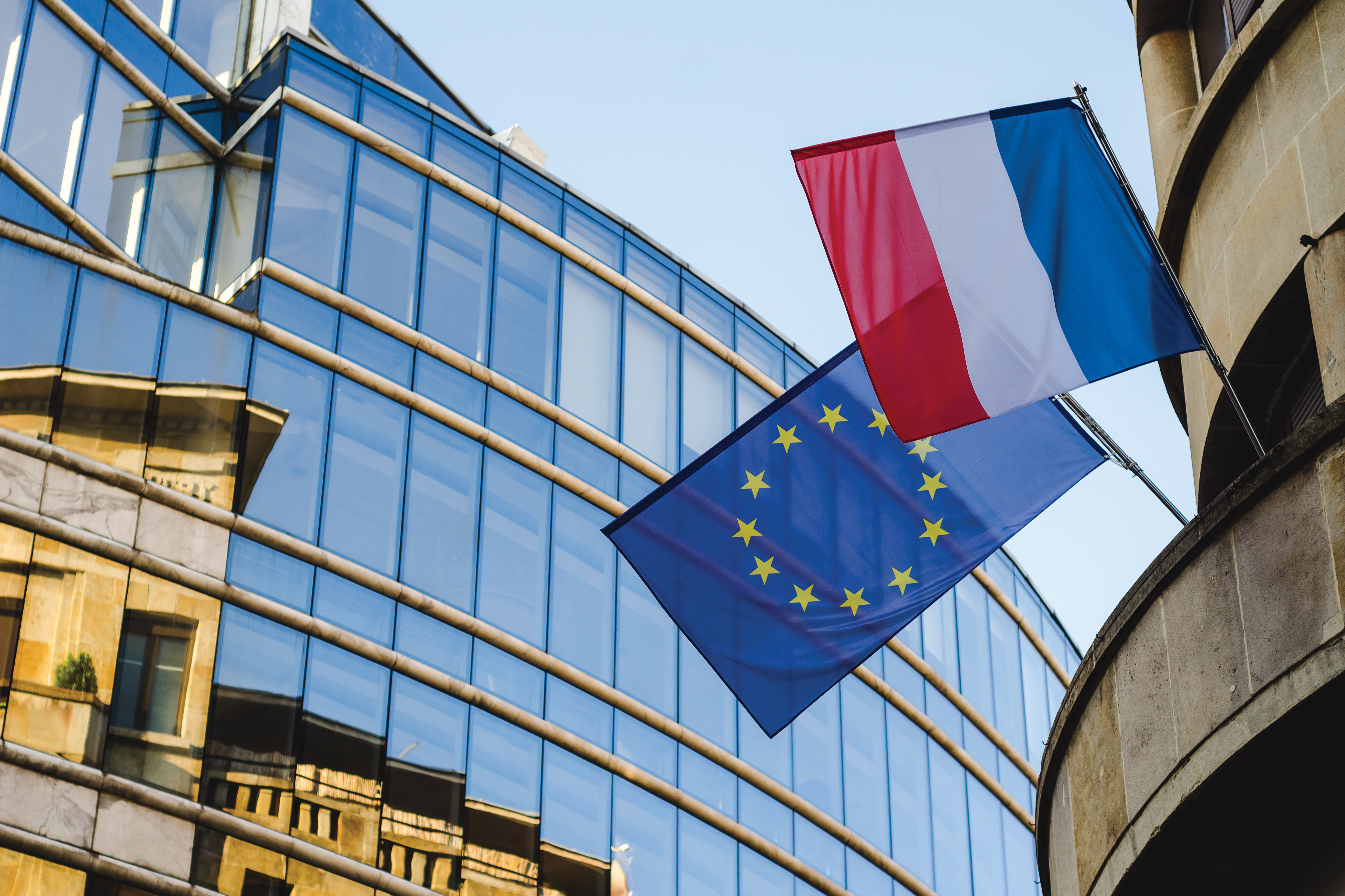 Flags on the building that regulates the conditions for obtaining French citizenship