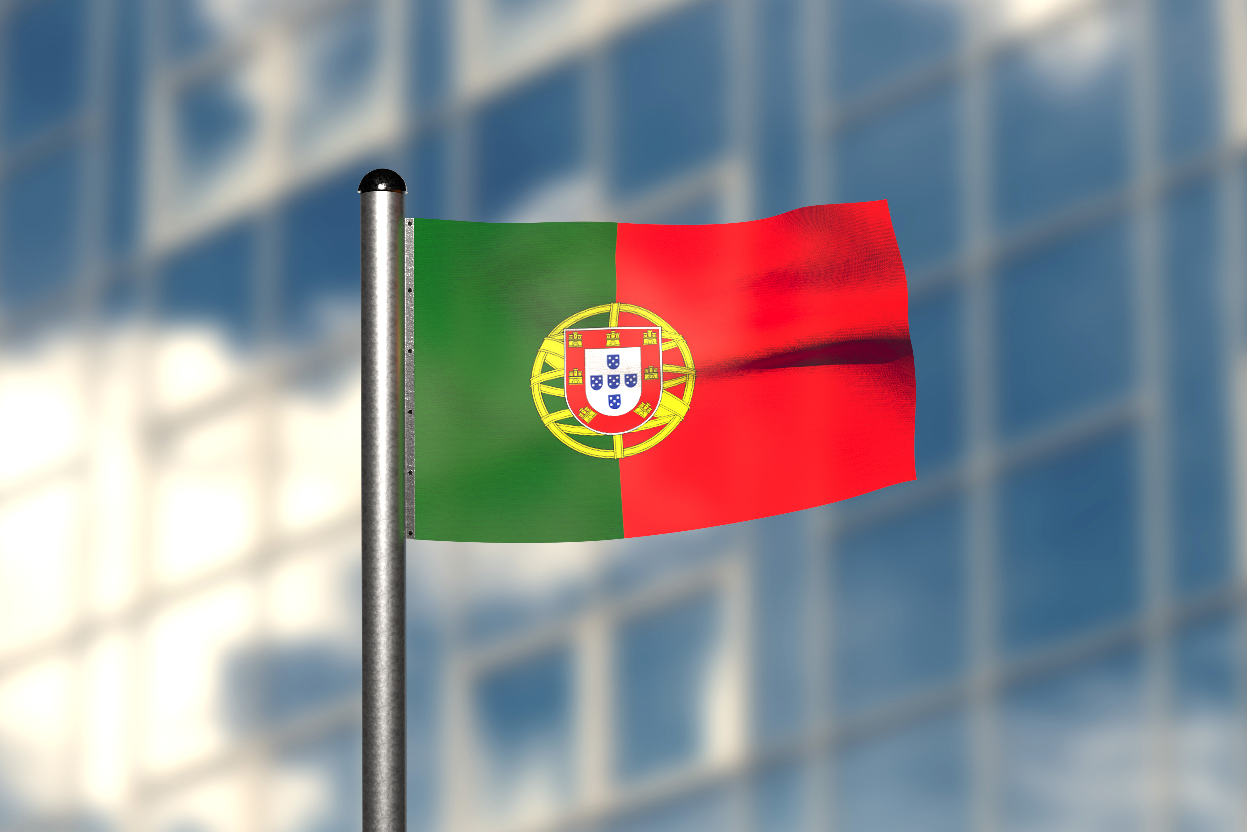 The Portuguese flag on the background of the building symbolizes obtaining a residence permit in Portugal when buying real estate