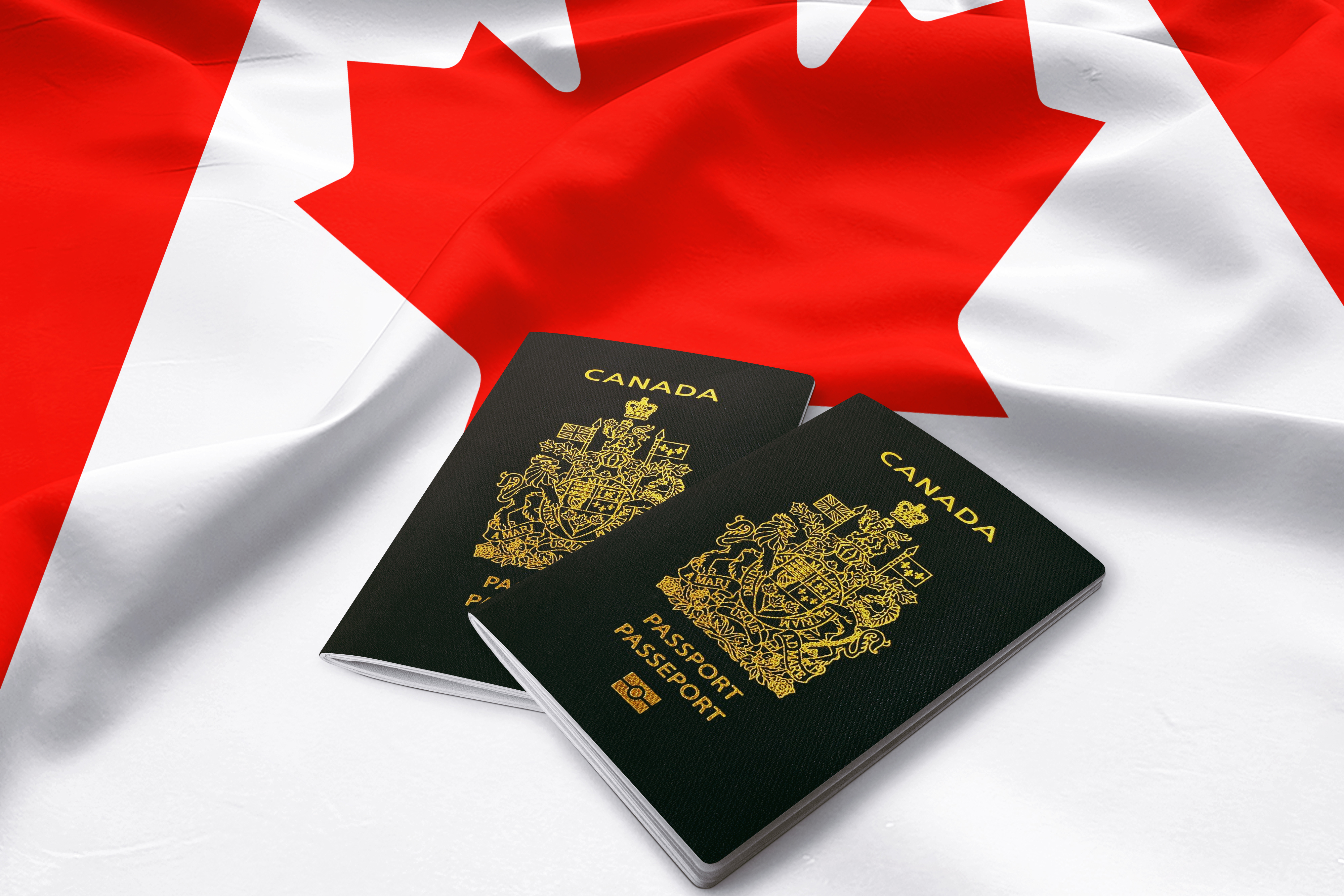 Canadian passports and flag as a symbol of self-employed persons program and immigration to Canada