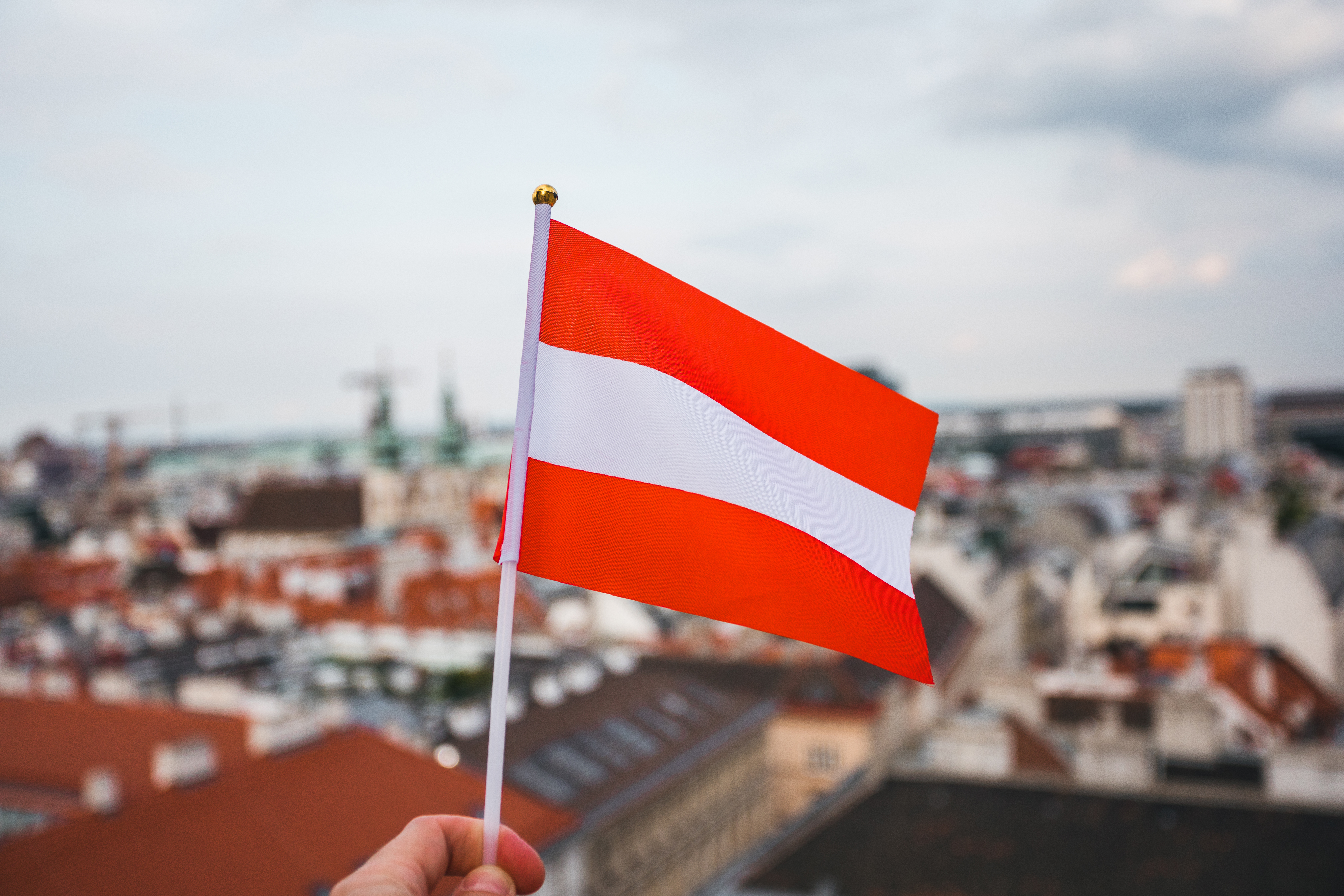 The flag symbolizes the citizenship of Austria